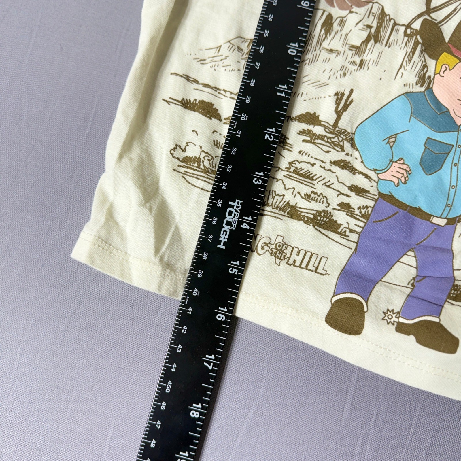 King of the Hill Rodeo Days Bobby Hill Graphic Ringer T-Shirt Cream Brown XS